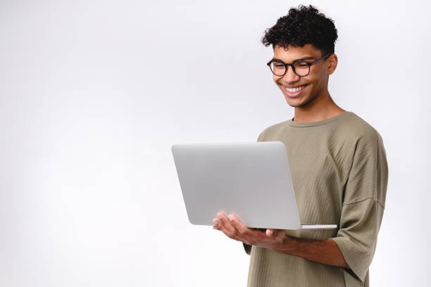 Smart young mixed-race student using laptop isolated over white background